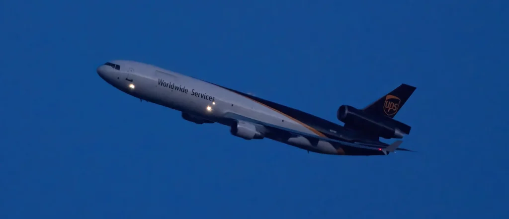 UPS MD-11 departs PHL in early evening skies.