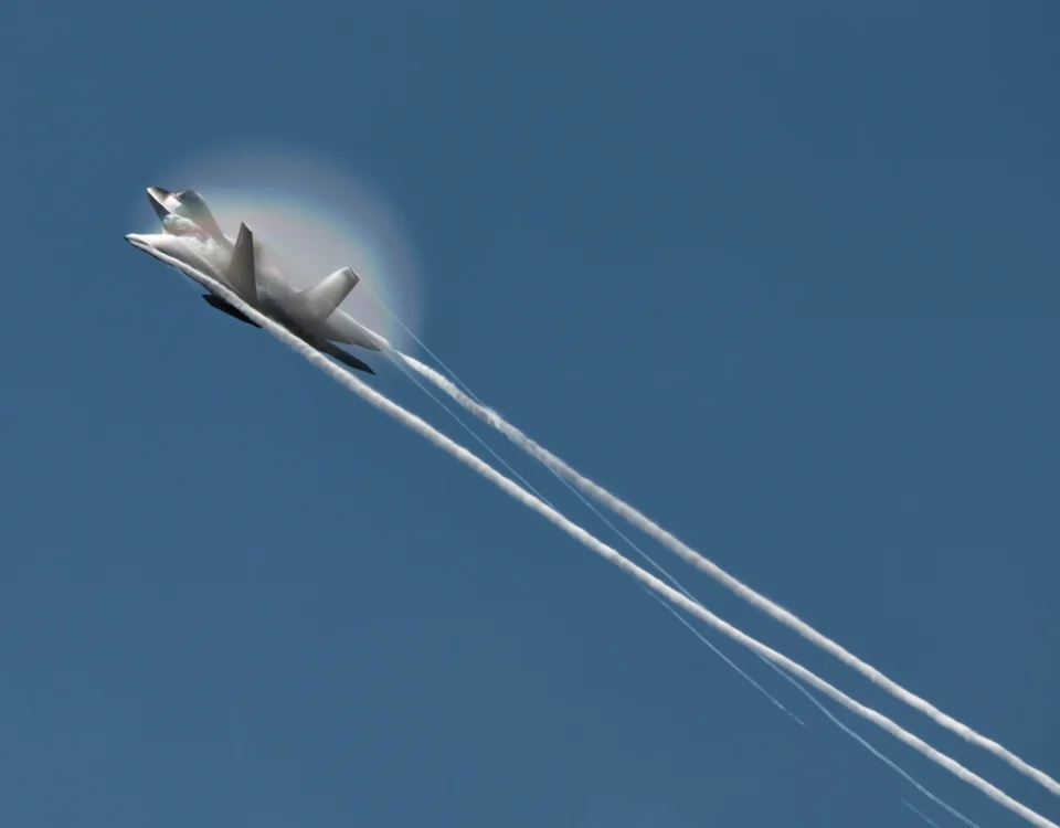 The F-22 generates vapor and a rainbow at NAS Oceana.